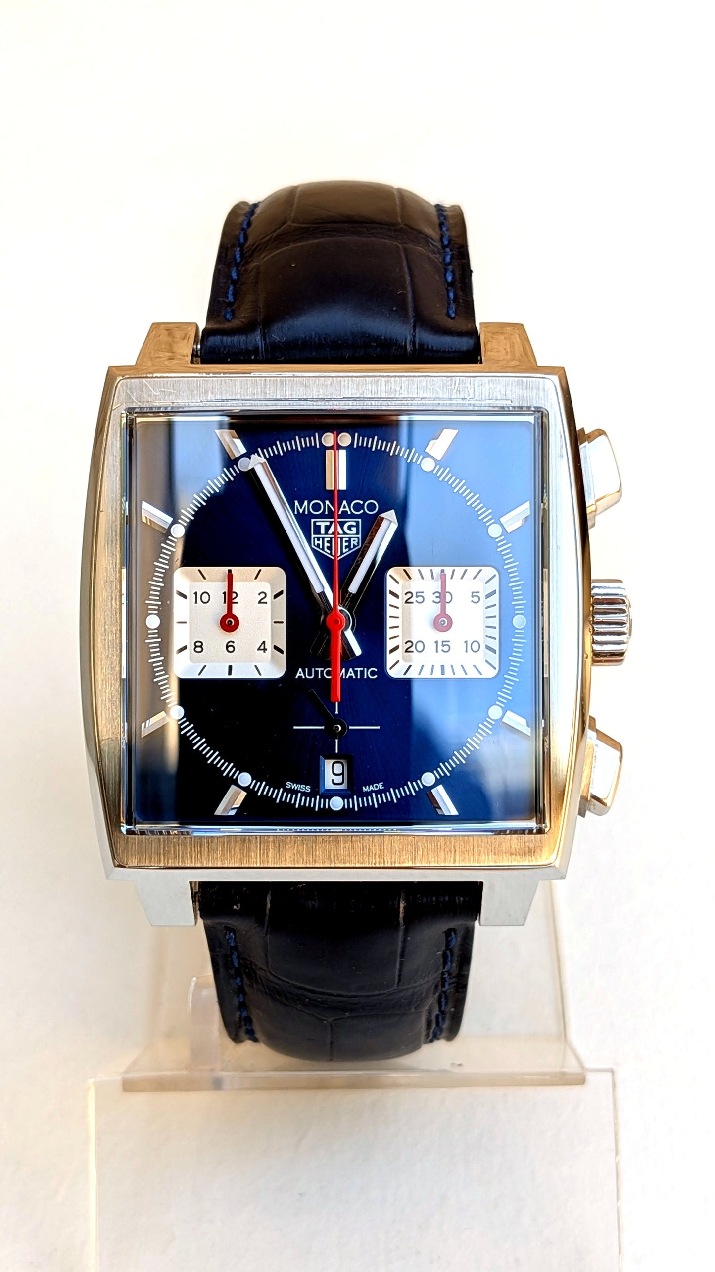 TAG Heuer Monaco face, cadran bleu lumineux, dateur à 6h et bracelet cuir surpiqué bleu, montre vintage homme