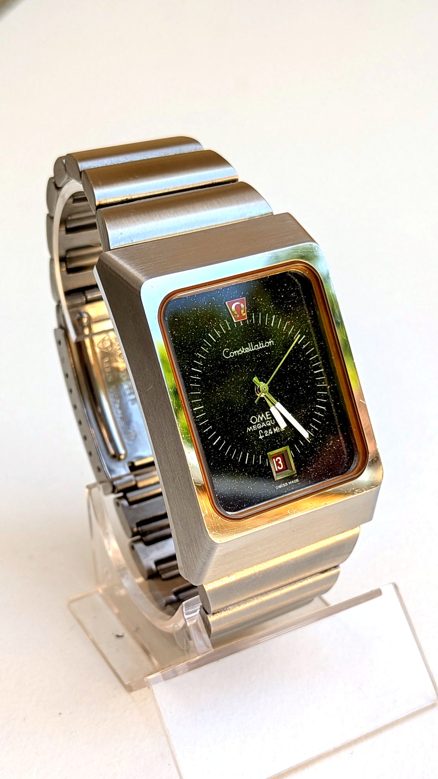 Omega Constellation Megaquartz cadran aventurine reflets verts de profil bracelet acier intégré, montre vintage homme